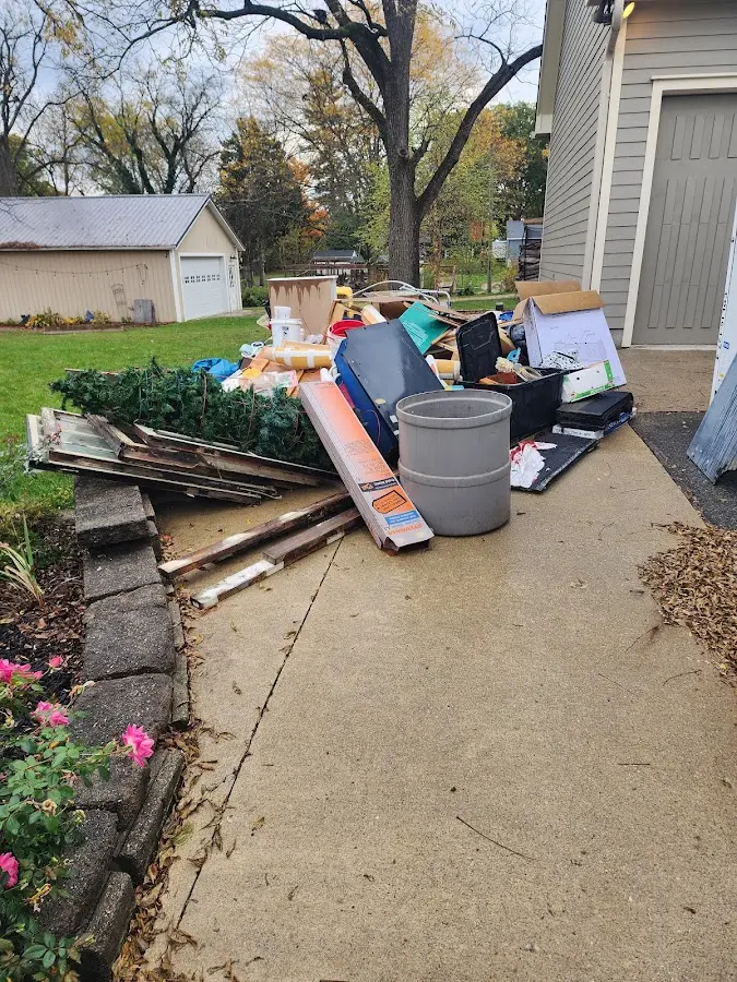 Dumpster being loaded with debris for Estate Cleanout Dumpster Rental in Stony Point
